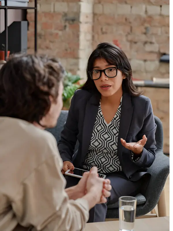 Professional consulting with a client in a supportive setting for HealthFirstFocus Mental Health section.